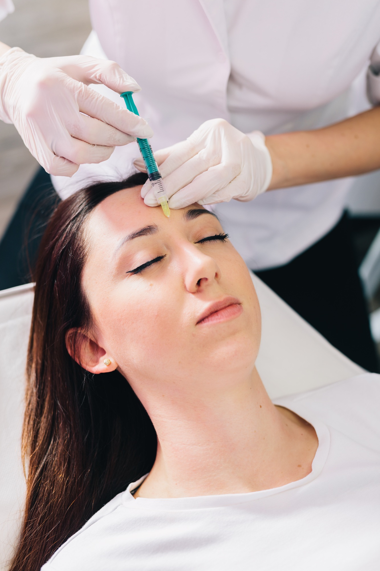 Injectable tissue stimulator on woman face in beauty salon